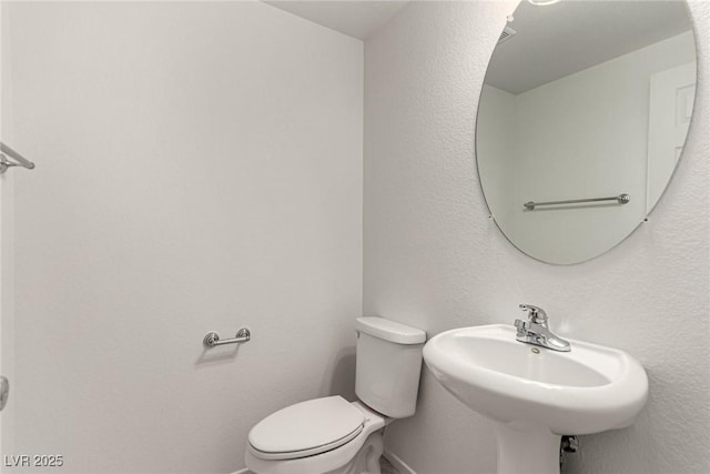 519 Brinkburn Point Ave, Las Vegas, NV 89178 - half bathroom with toilet, baseboards, and a sink