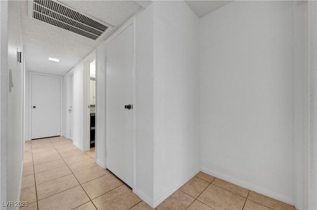 2377 Los Feliz St, Las Vegas, NV 89156 - hallway featuring baseboards, light tile patterned floors, and visible vents