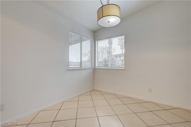 2377 Los Feliz St, Las Vegas, NV 89156 - spare room with a textured ceiling, baseboards, and light tile patterned flooring