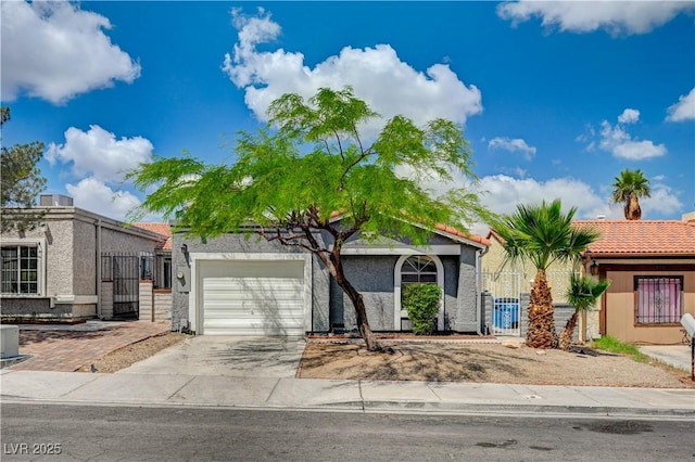 2377 Los Feliz St, Las Vegas, NV 89156 - view of front of house featuring a garage, a gate, concrete driveway, and fence