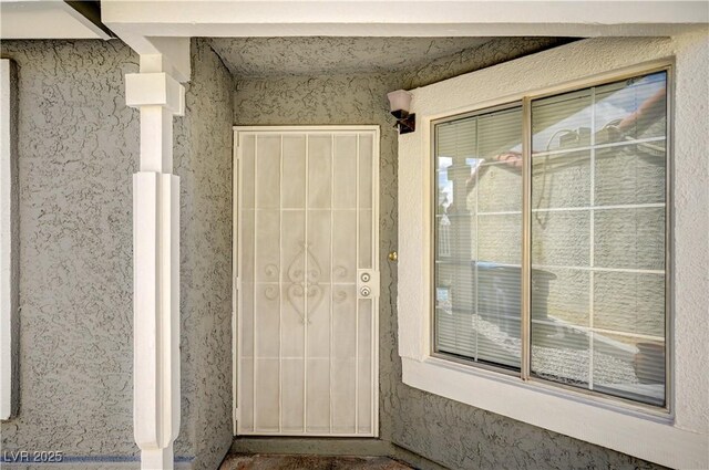 2377 Los Feliz St, Las Vegas, NV 89156 - doorway to property with stucco siding