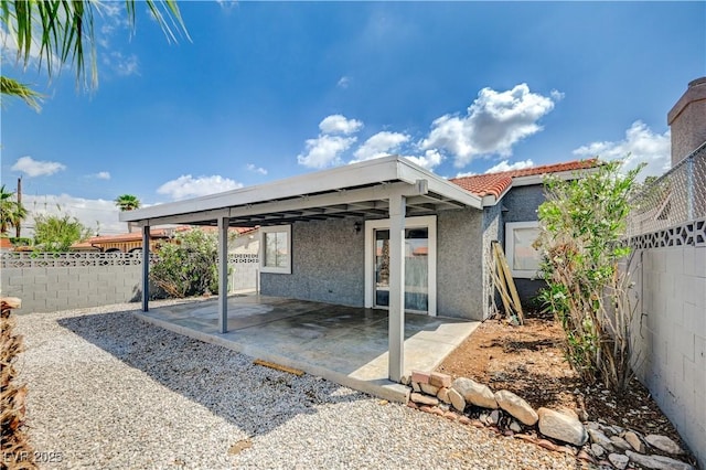 2377 Los Feliz St, Las Vegas, NV 89156 - rear view of house with stucco siding, a patio, a fenced backyard, and a tile roof