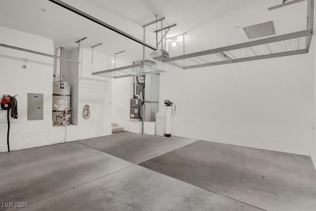 garage with strapped water heater, a garage door opener, and electric panel
