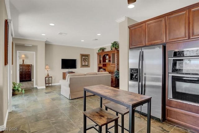 kitchen with recessed lighting, stone finish flooring, appliances with stainless steel finishes, and baseboards