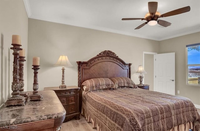 bedroom featuring light wood-type flooring, crown molding, and a ceiling fan