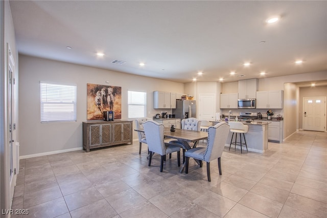 dining area featuring baseboards, visible vents, recessed lighting, and light tile patterned floors