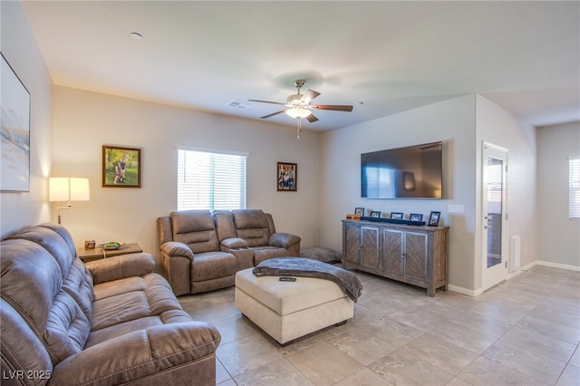 living area featuring ceiling fan, baseboards, visible vents, and light tile patterned floors