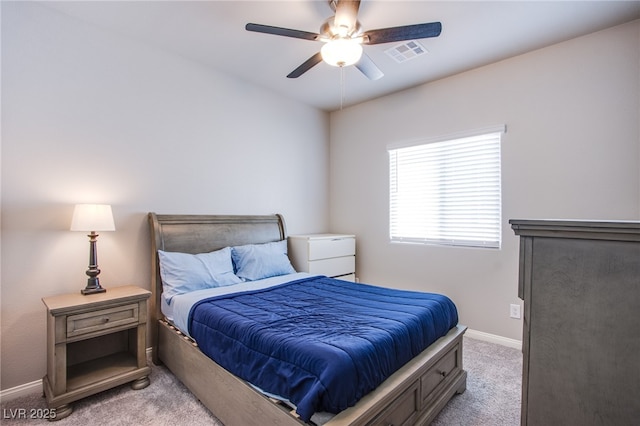 bedroom with baseboards, visible vents, a ceiling fan, and light colored carpet