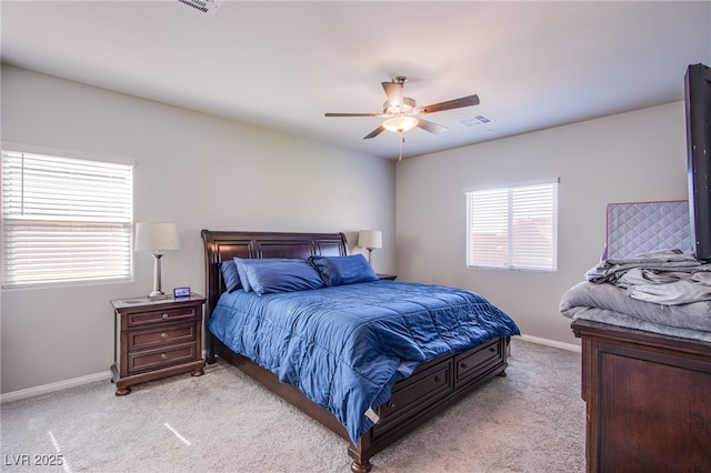 bedroom with light colored carpet, baseboards, a ceiling fan, and visible vents