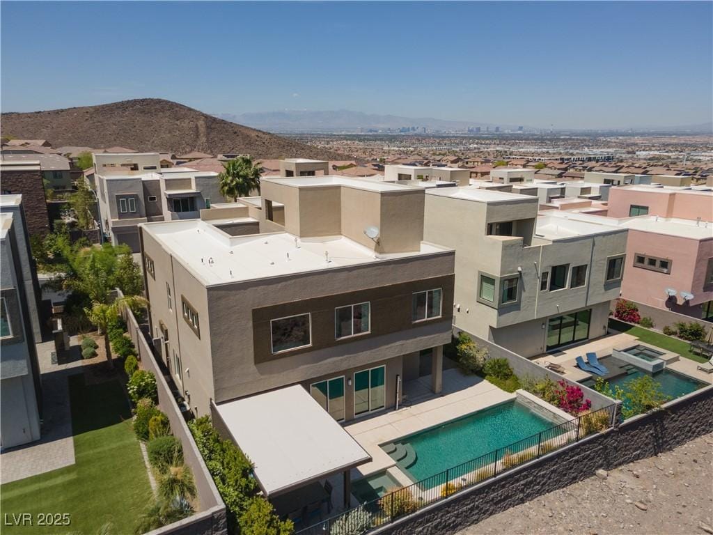 drone / aerial view featuring a residential view and a mountain view