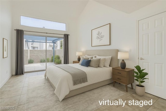 bedroom with a towering ceiling, access to outside, and light tile patterned floors