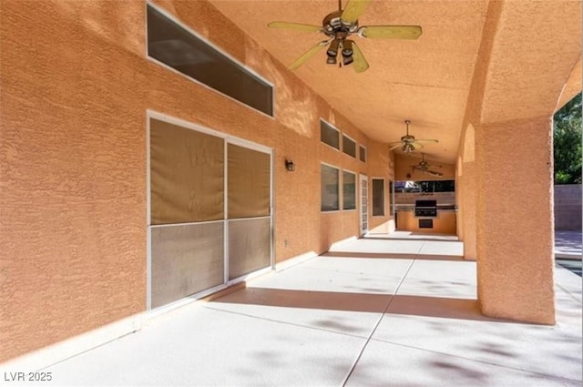 view of patio featuring exterior kitchen and ceiling fan