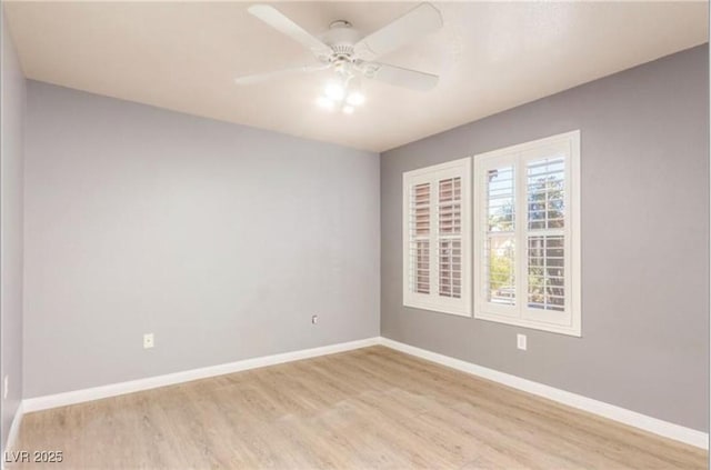 empty room with a ceiling fan, baseboards, and light wood-style floors