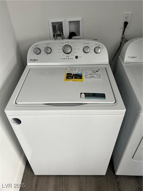 laundry room with wood finished floors, laundry area, and washer / clothes dryer