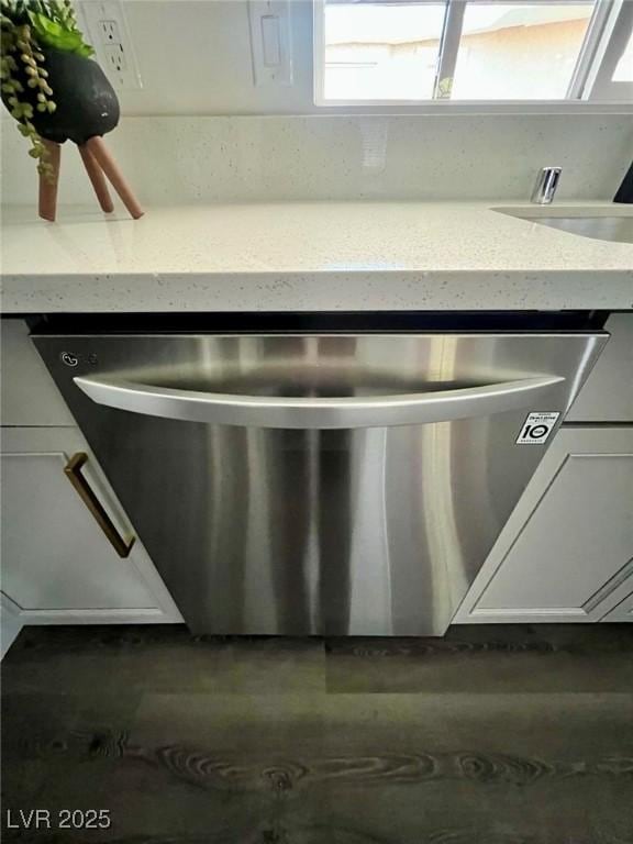 details featuring white cabinets and light stone countertops