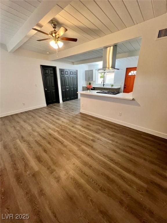 unfurnished living room with beamed ceiling, wood finished floors, visible vents, and wooden ceiling