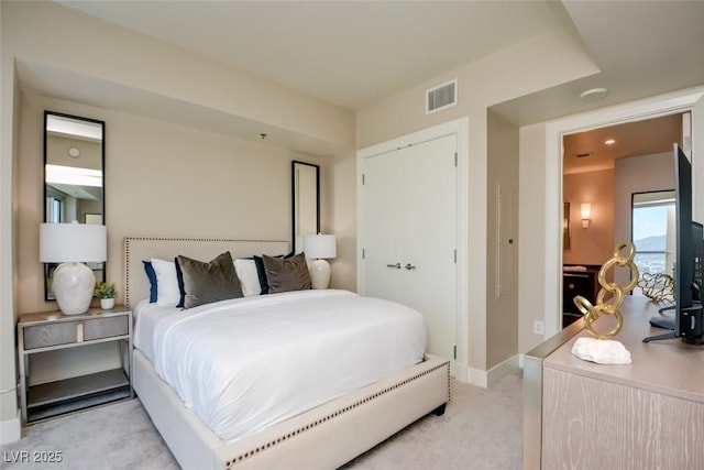 bedroom with light colored carpet, baseboards, and visible vents