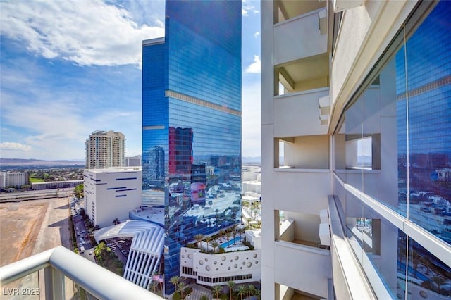 balcony featuring central air condition unit and a city view