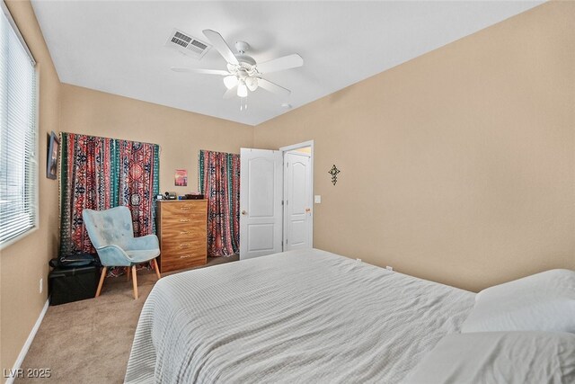 bedroom featuring baseboards, a ceiling fan, visible vents, and light colored carpet