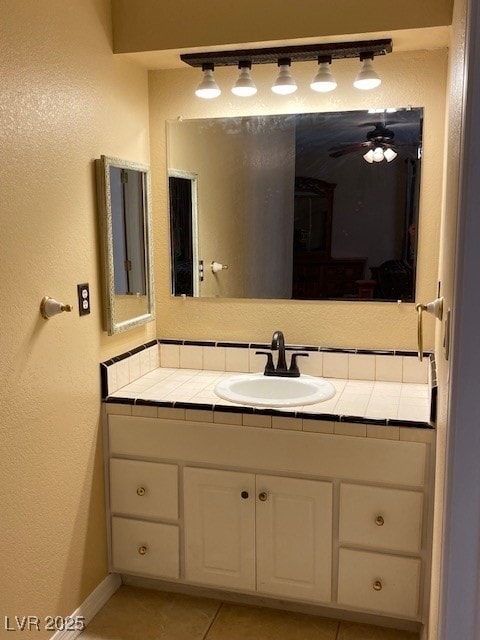 bathroom featuring tile patterned flooring, ceiling fan, baseboards, and vanity