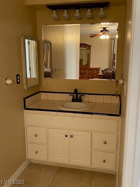 bathroom with baseboards, vanity, tile patterned flooring, and ceiling fan