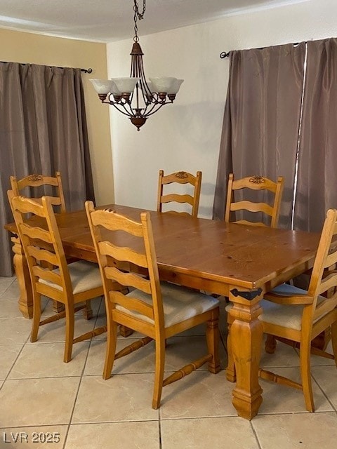 dining area with a notable chandelier and light tile patterned flooring
