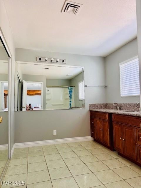 6786 Grandola Dr, Las Vegas, NV 89103 - interior space with baseboards, visible vents, tile patterned flooring, a shower with shower curtain, and vanity