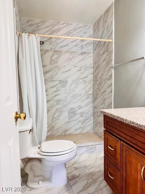6786 Grandola Dr, Las Vegas, NV 89103 - bathroom featuring tiled shower, vanity, marble finish floor, and toilet