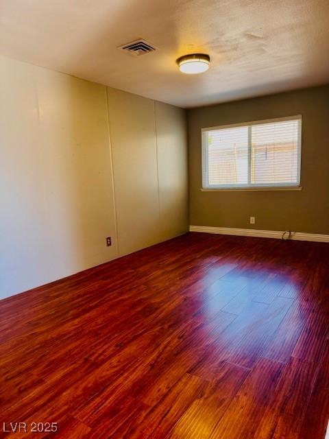 6786 Grandola Dr, Las Vegas, NV 89103 - empty room featuring wood finished floors and visible vents