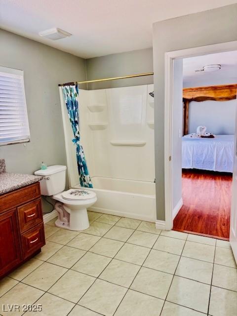 6786 Grandola Dr, Las Vegas, NV 89103 - full bathroom with toilet, baseboards, shower / bath combo with shower curtain, tile patterned flooring, and vanity