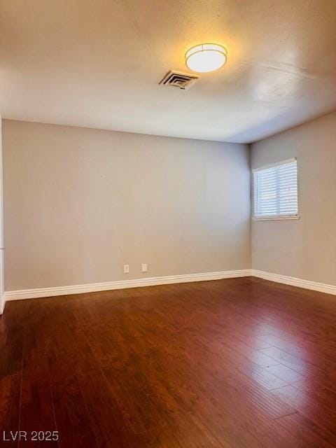 6786 Grandola Dr, Las Vegas, NV 89103 - unfurnished room with baseboards, visible vents, and dark wood-type flooring
