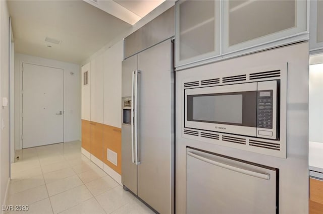3726 S Las Vegas Blvd Unit 1003, Las Vegas, NV 89158 - kitchen featuring appliances with stainless steel finishes, gray cabinetry, glass insert cabinets, light tile patterned flooring, and baseboards