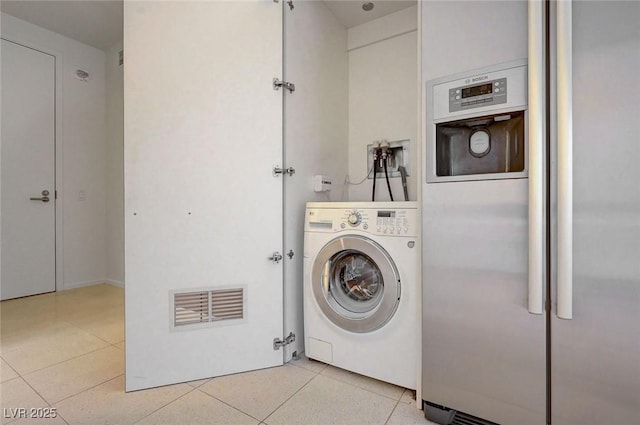 3726 S Las Vegas Blvd Unit 1003, Las Vegas, NV 89158 - washroom featuring washer / clothes dryer and light tile patterned floors