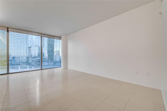 3726 S Las Vegas Blvd Unit 1003, Las Vegas, NV 89158 - tiled spare room featuring expansive windows