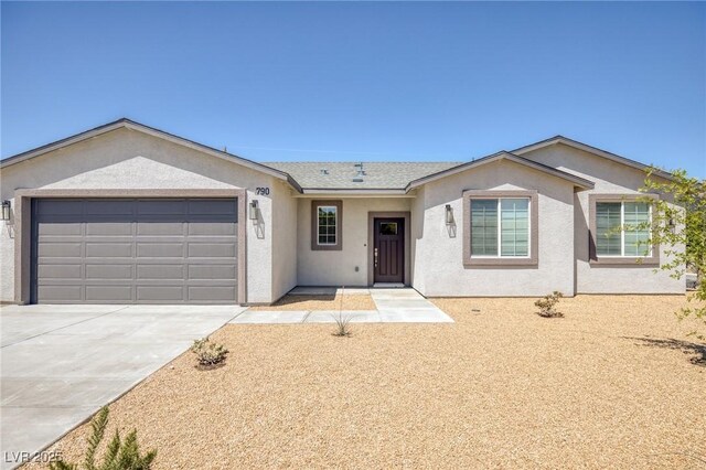 790 Lone Pine Rd, Pahrump, NV 89048 - ranch-style home with a garage, stucco siding, and driveway