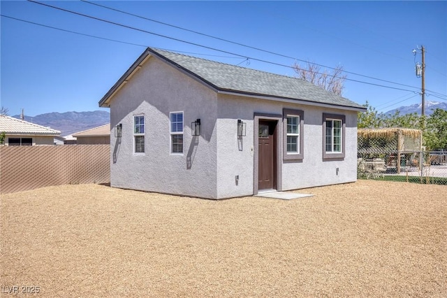 790 Lone Pine Rd, Pahrump, NV 89048 - back of property featuring stucco siding, a mountain view, and roof with shingles