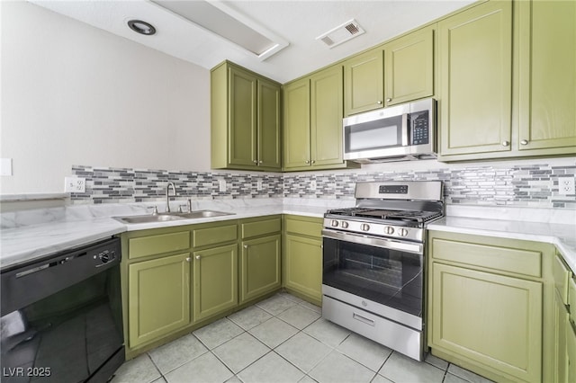 1400 Jamielinn Ln Unit 104, Las Vegas, NV 89110 - kitchen with appliances with stainless steel finishes, green cabinets, decorative backsplash, and light tile patterned floors