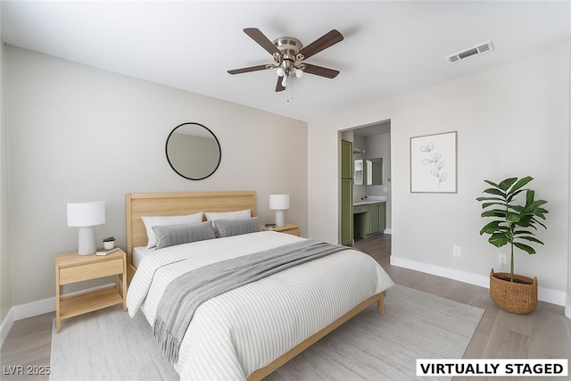 1400 Jamielinn Ln Unit 104, Las Vegas, NV 89110 - bedroom with wood finished floors, connected bathroom, and a ceiling fan