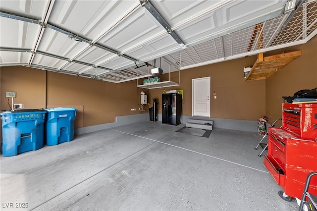 10664 Mount Jefferson Ave, Las Vegas, NV 89166 - garage featuring black refrigerator with ice dispenser and a garage door opener