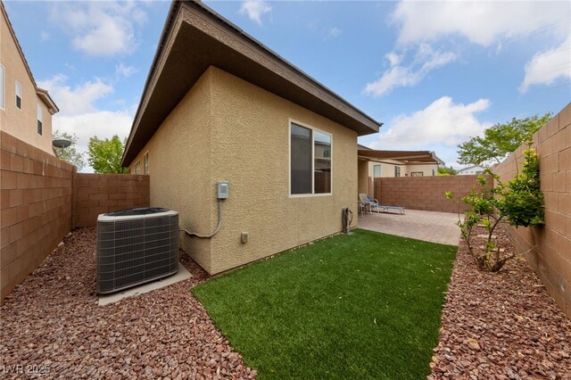 10664 Mount Jefferson Ave, Las Vegas, NV 89166 - view of home's exterior with central AC unit, stucco siding, and a patio