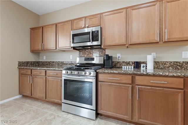 10664 Mount Jefferson Ave, Las Vegas, NV 89166 - kitchen with stainless steel appliances, dark stone counters, and brown cabinetry