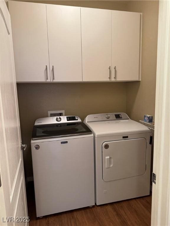 10664 Mount Jefferson Ave, Las Vegas, NV 89166 - washroom featuring washer and clothes dryer, dark wood finished floors, and cabinet space