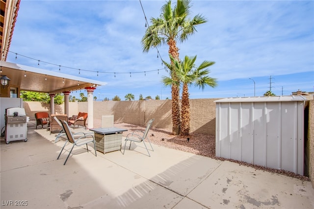 1552 Livingston Dr, Henderson, NV 89012 - fenced backyard with a patio area, area for grilling, and a storage unit