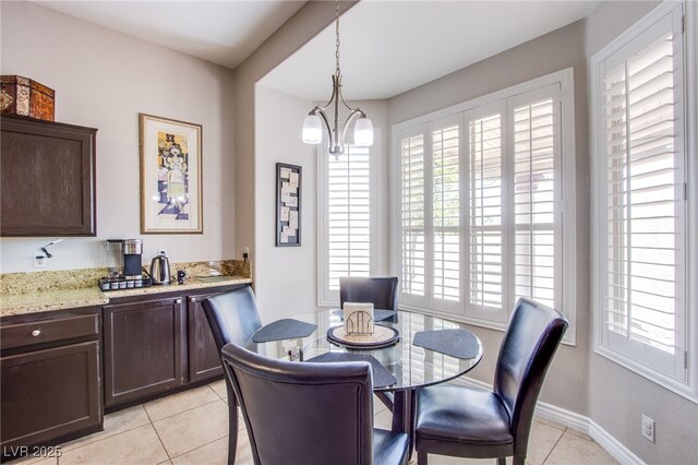1552 Livingston Dr, Henderson, NV 89012 - dining area with light tile patterned flooring, healthy amount of natural light, and a chandelier
