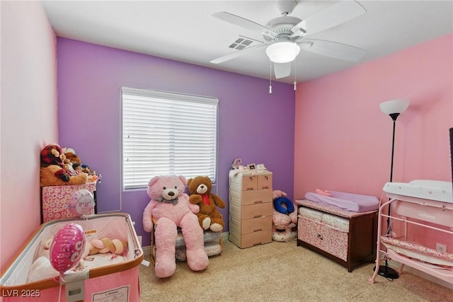 carpeted bedroom featuring a ceiling fan and visible vents