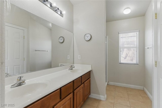 bathroom featuring tile patterned floors, baseboards, and a sink