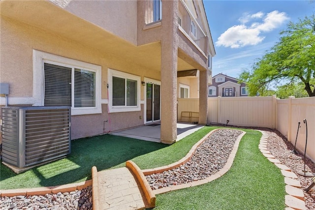 view of yard with central air condition unit, a patio, and a fenced backyard