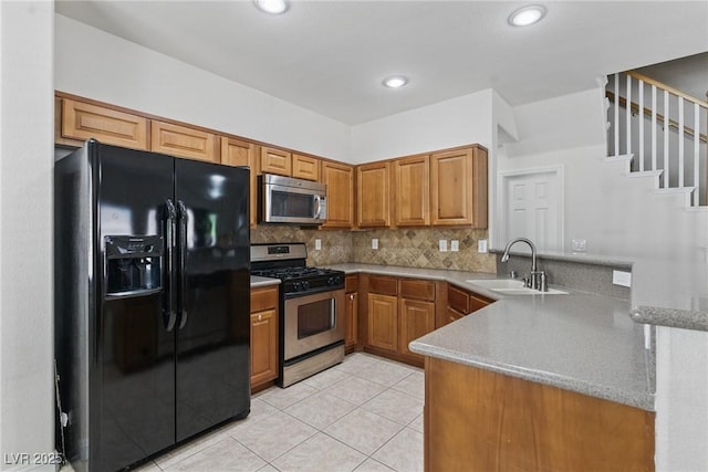 1069 Thrill Ct Unit 102, Henderson, NV 89002 - kitchen featuring stainless steel appliances, a sink, a peninsula, brown cabinetry, and recessed lighting