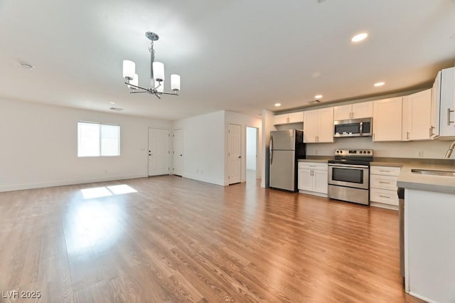 kitchen with white cabinetry, an inviting chandelier, recessed lighting, and appliances with stainless steel finishes
