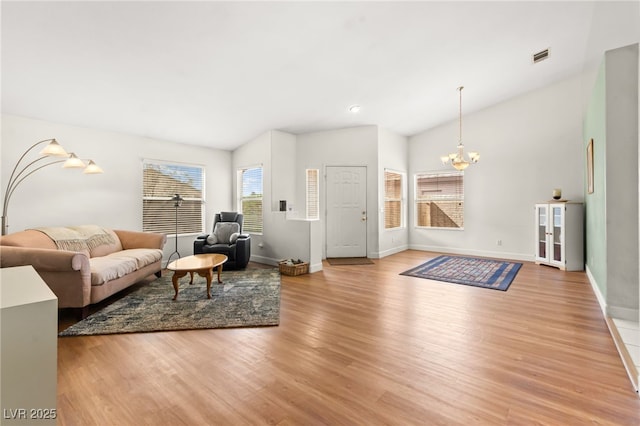 5224 Dana Springs Way, Las Vegas, NV 89130 - living area featuring lofted ceiling, light wood-type flooring, and an inviting chandelier